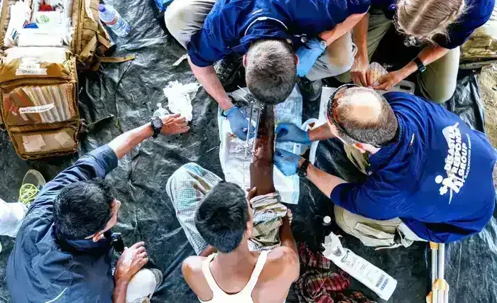 ExRMed medics treating an injured leg of a Rohingya refugee