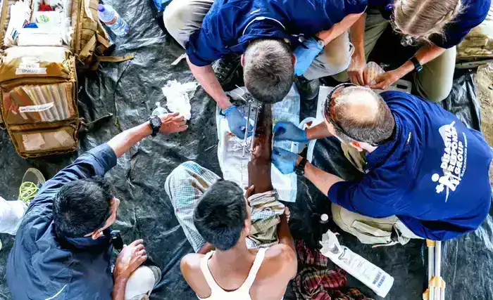 ExRMed medics treating an injured leg of a Rohingya refugee